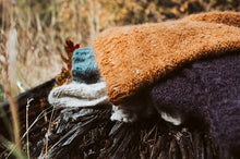 Load image into Gallery viewer, Textured fabric pieces in brown, purple, and blue on a natural background