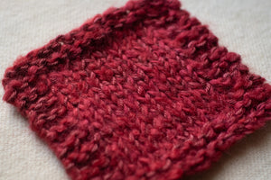 Red knitted fabric on a light background