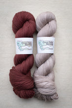 Load image into Gallery viewer, Two skeins of yarn, one red-brown and one beige, with labels on a light gray background.