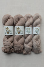 Load image into Gallery viewer, Four skeins of yarn in soft taupe and blush-beige shades, arranged side by side on a light neutral fabric background. Each skein has a white label with a ram illustration and the brand name Fish Run Hand Dyed.