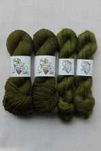 Load image into Gallery viewer, Four skeins of olive green yarn from Fishkin Yarns, arranged side by side on a light gray textured fabric background.