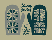 Load image into Gallery viewer, A graphic design featuring two oven mitts with floral cutout patterns on a muted beige background. One mitt is gray and the other is dark teal, both with cream outlines.
