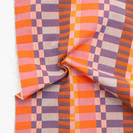 Checkered fabric with orange, purple, and pink colors on a white background
