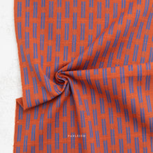 Load image into Gallery viewer, Orange fabric with blue pattern and 'Fableism' branding on a white background
