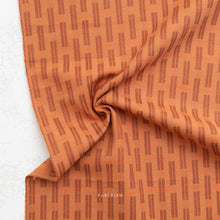 Load image into Gallery viewer, Orange fabric with a subtle pattern on a white background, branded 'Fableism'.