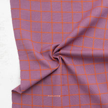 Load image into Gallery viewer, Purple fabric with orange grid pattern on a white background, featuring the brand 'Fableism'.
