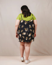 Load image into Gallery viewer, Person wearing a floral dress over a green shirt against a plain background