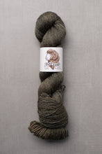 Load image into Gallery viewer, skein of yarn with a label on a gray background