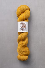 Load image into Gallery viewer, Yellow skein of yarn with a label on a gray background