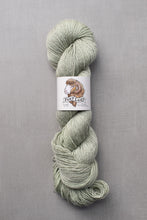 Load image into Gallery viewer, Skein of green yarn with a label on a gray background