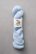Load image into Gallery viewer, Light blue skein of yarn with a label on a gray background