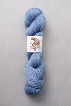 Load image into Gallery viewer, Blue skein of yarn with a label on a gray background