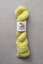 Load image into Gallery viewer, Yellow skein of yarn with a label on a gray background