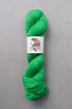 Load image into Gallery viewer, Green skein of yarn with a label on a gray background