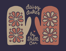 Load image into Gallery viewer, A stylized graphic showing two oven mitts with floral cutout patterns on a dark navy background, with the text 'daisy dukes' and 'by Shelli Can' in a handwritten cream font.
