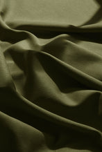 Load image into Gallery viewer, Close-up of green fabric with folds