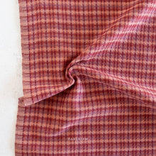 Load image into Gallery viewer, Close-up of a folded piece of red and white checkered fabric on a white background