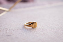 Load image into Gallery viewer, Gold ring with engraved text on a textured surface
