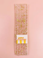 Clear ruler with floral design on a pink background