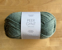 Load image into Gallery viewer, Ball of green yarn with a label on a wooden surface