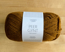 Load image into Gallery viewer, Ball of yarn with a label on a wooden surface