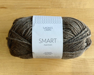 Ball of yarn with a label on a wooden surface