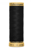 Spool of black thread with 'Gütermann' branding on a white background