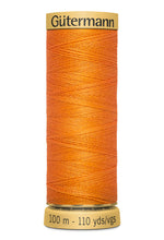 Load image into Gallery viewer, Spool of orange thread with 'Gärtnermann' branding on a white background