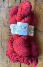 Load image into Gallery viewer, Red yarn skeins with &#39;Great Falls Montana&#39; label on a wooden surface