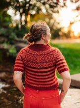 Load image into Gallery viewer, Person wearing a red and brown patterned sweater in an outdoor setting