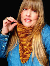 Load image into Gallery viewer, Woman wearing a knitted mustard yellow scarf against a black background