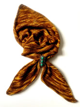 Load image into Gallery viewer, Brown textured fabric with a decorative brooch on a white background