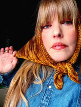 Load image into Gallery viewer, Woman wearing a yellow knitted headscarf with a dark background
