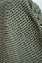 Load image into Gallery viewer, Close-up of a textured green fabric with a neutral background