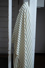 Load image into Gallery viewer, Striped shirt hanging on a white metal rack against a neutral background