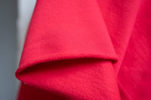 Load image into Gallery viewer, Close-up of red fabric with a textured pattern