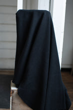 Load image into Gallery viewer, Dark fabric draped over a white surface with a blurred background