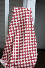 Load image into Gallery viewer, Red and white checkered fabric draped over a white railing.