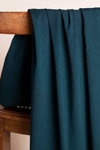Load image into Gallery viewer, Teal fabric draped over a wooden surface