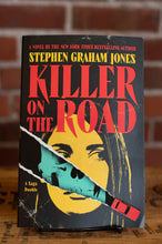 Load image into Gallery viewer, Book cover of 'Killer on the Road' by Stephen Graham Jones against a brick wall background
