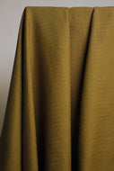 Mustard yellow fabric draped over a neutral background