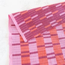 Load image into Gallery viewer, Textile with pink and orange geometric pattern on a white background