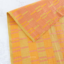 Load image into Gallery viewer, Yellow and orange checkered fabric with 'Fableism' branding on a white background