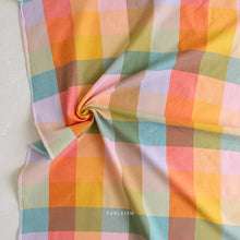 Load image into Gallery viewer, Colorful checkered fabric with 'Fableism' branding on a light background