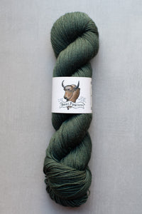 Green skein of yarn with a label on a gray background
