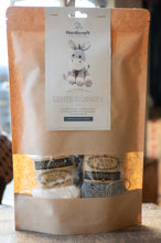 Load image into Gallery viewer, Knitting kit packaging with a donkey design on a wooden surface