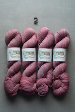 Load image into Gallery viewer, Four skeins of pink yarn with labels on a gray background