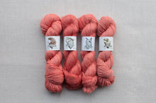 Load image into Gallery viewer, Four skeins of pink yarn with labels on a gray background