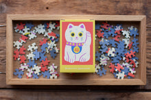 Load image into Gallery viewer, Jigsaw puzzle with a cat-themed box on a wooden surface