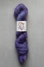 Load image into Gallery viewer, Purple yarn skein with a label on a gray background